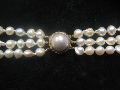 Appraisal: Three strand pearl choker Yellow gold clasp accented by a