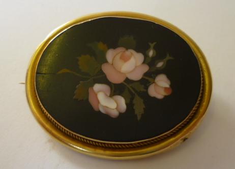 Appraisal: A PIETRA DURA BROOCH the oval plaque inlaid with pink