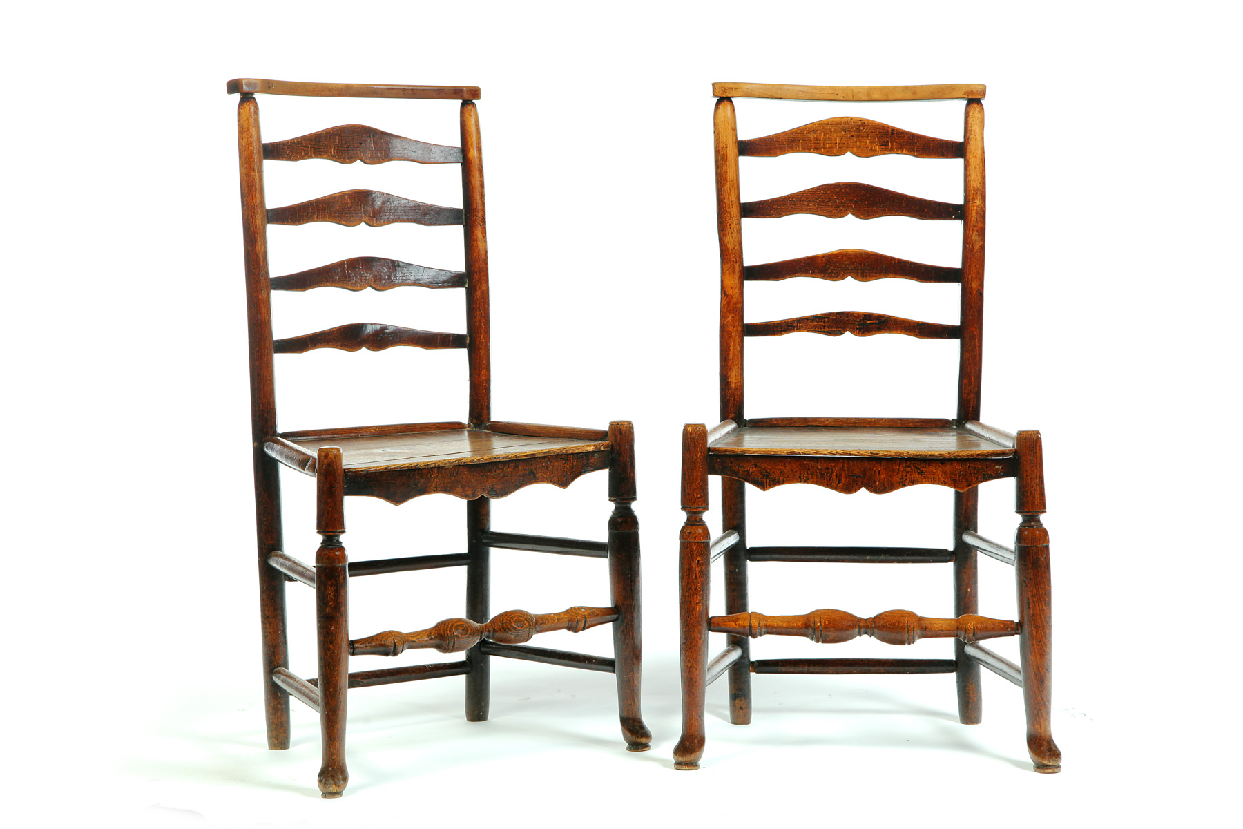 Appraisal: PAIR OF ENGLISH LADDERBACK CHAIRS Nineteenth century mixed woods Plank