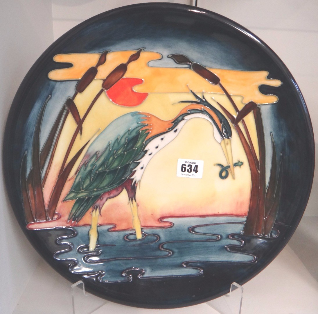 Appraisal: A Moorcroft heron design 'Reeds at Sunset' charger circa cm