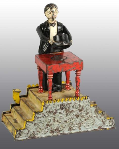 Appraisal: Cast Iron Magician Mechanical Bank Description Manufactured by J E