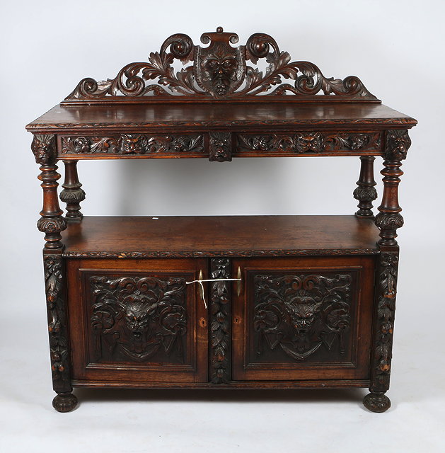 Appraisal: A VICTORIAN OAK SIDEBOARD with animal mask and scrolling foliate