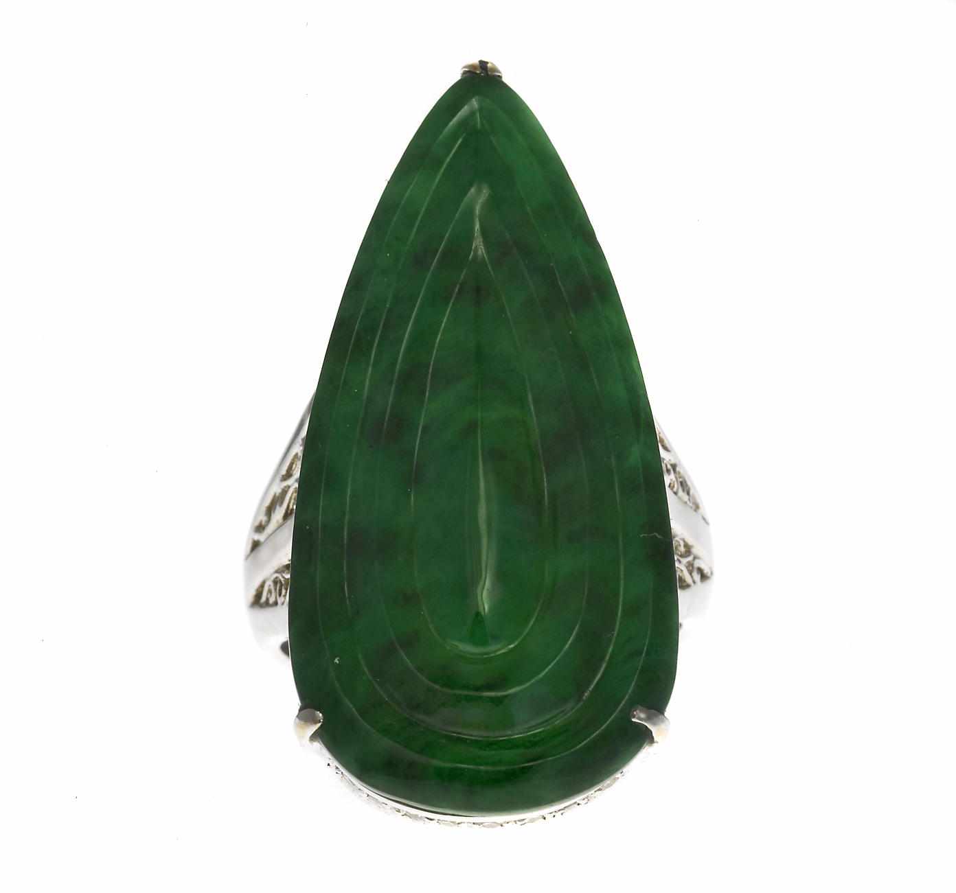 Appraisal: A carved jadeite jade and diamond pendant ring Adler pear-shaped