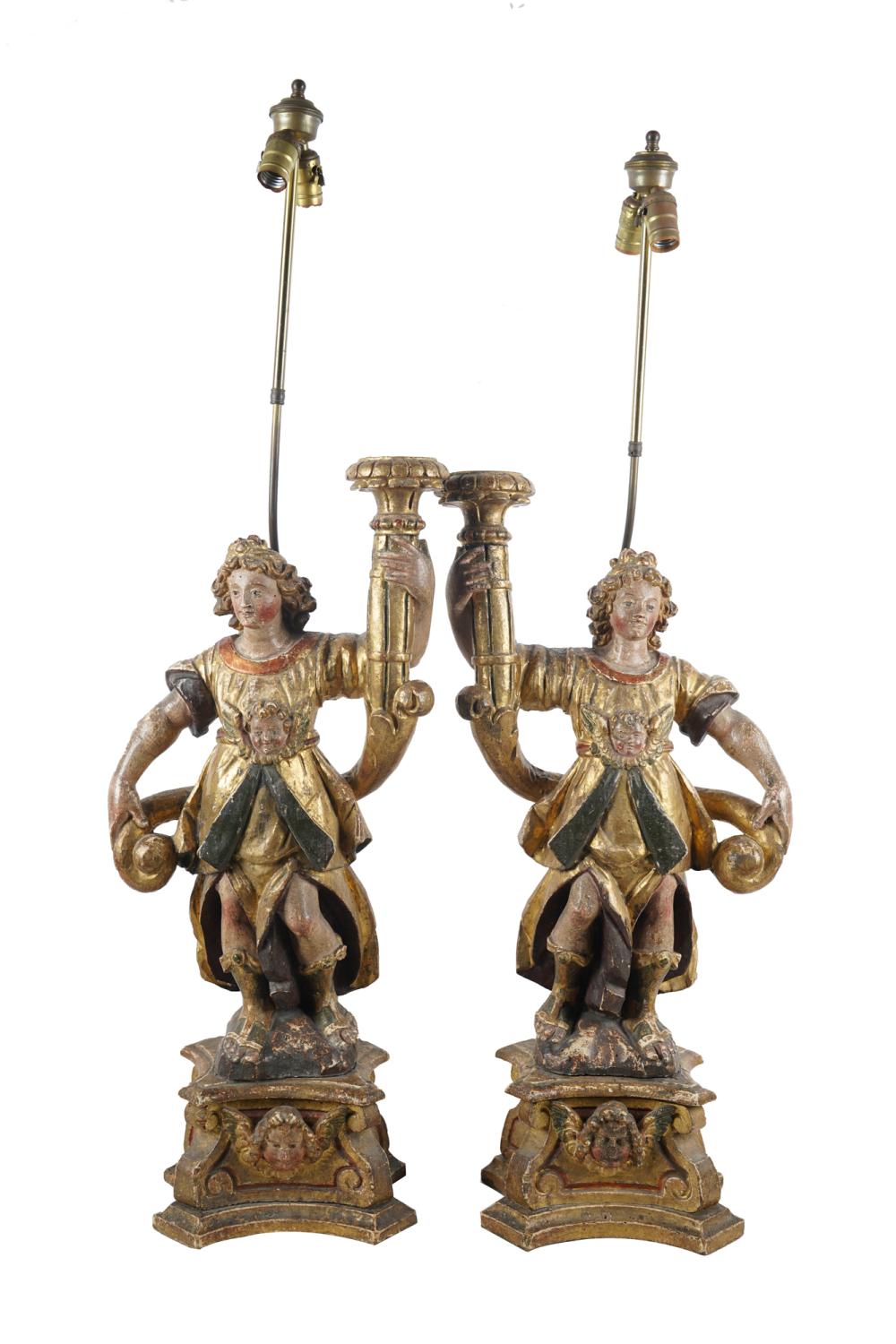 Appraisal: PAIR OF PAINTED WOOD SANTOSmounted and electrified as table lamps