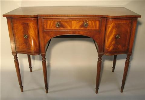 Appraisal: REGENCY STYLE SERPENTINE FRONT SIDEBOARD th century the rectangular top