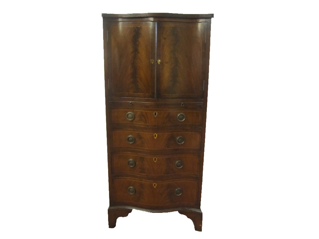 Appraisal: A mahogany serpentine fronted cupboard chest the two door cupboard