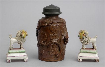 Appraisal: PAIR OF STAFFORDSHIRE POODLES AND A BROWN-GLAZED STONEWARE JAR The