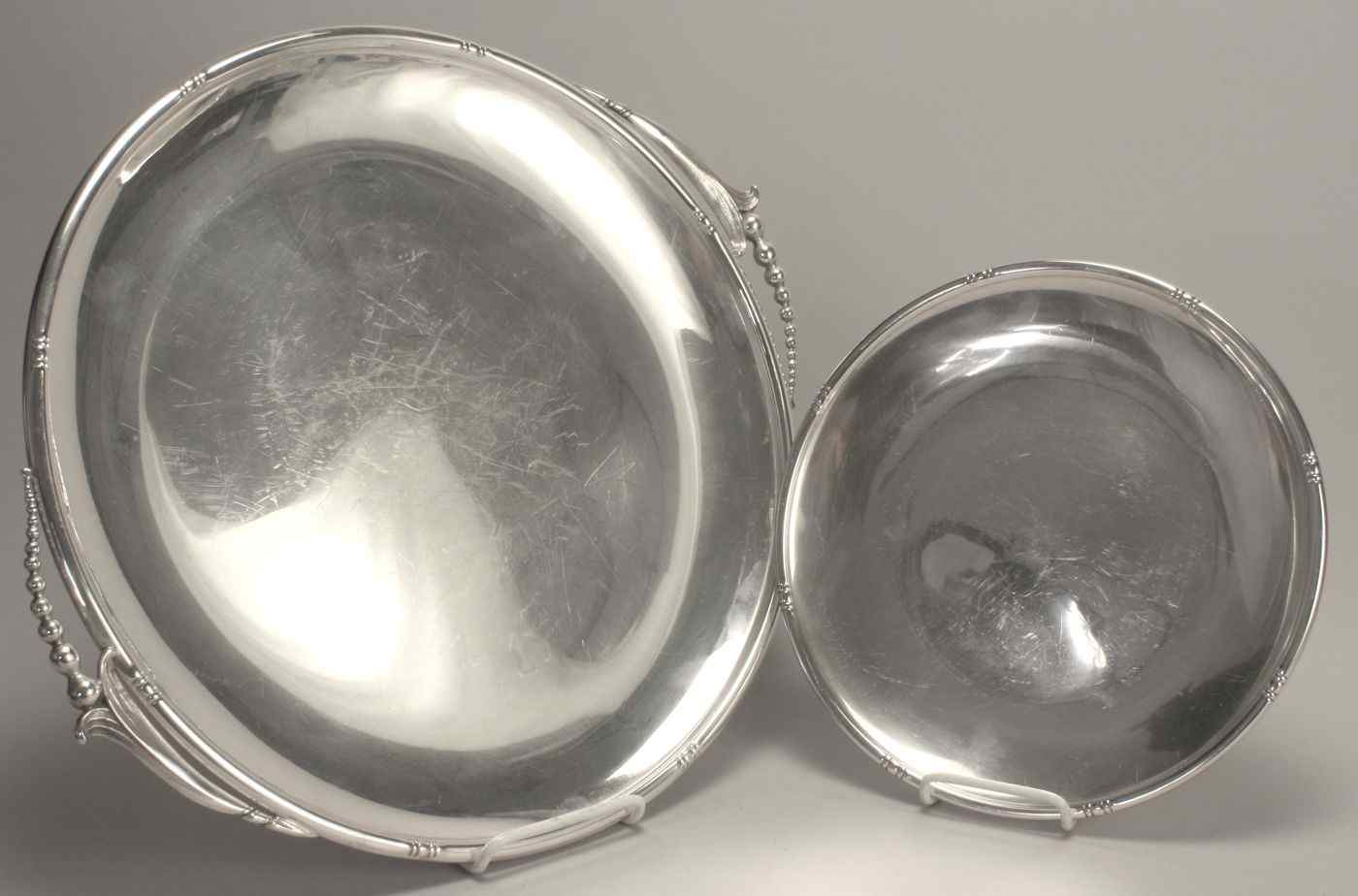 Appraisal: TWO STERLING SILVER TRAYSIn circular form One with applied grape