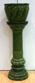 Appraisal: A green majolica jardiniere and stand with floral decoration th