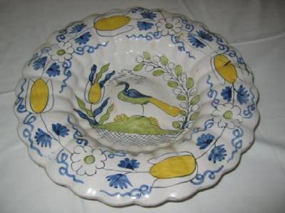 Appraisal: A CONTINENTAL DELFT CHARGER with lobed rim painted in polychrome