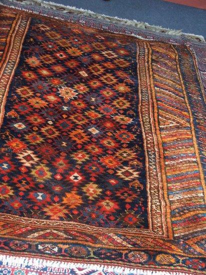 Appraisal: AN EASTERN MULTI-COLOURED WOOLLEN RUG with multiple star blue ground