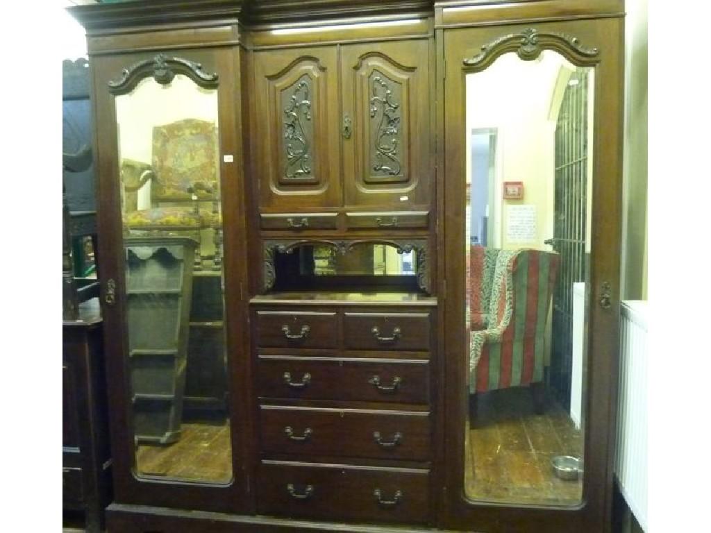 Appraisal: An Edwardian mahogany inverted breakfront triple wardrobe with stepped and