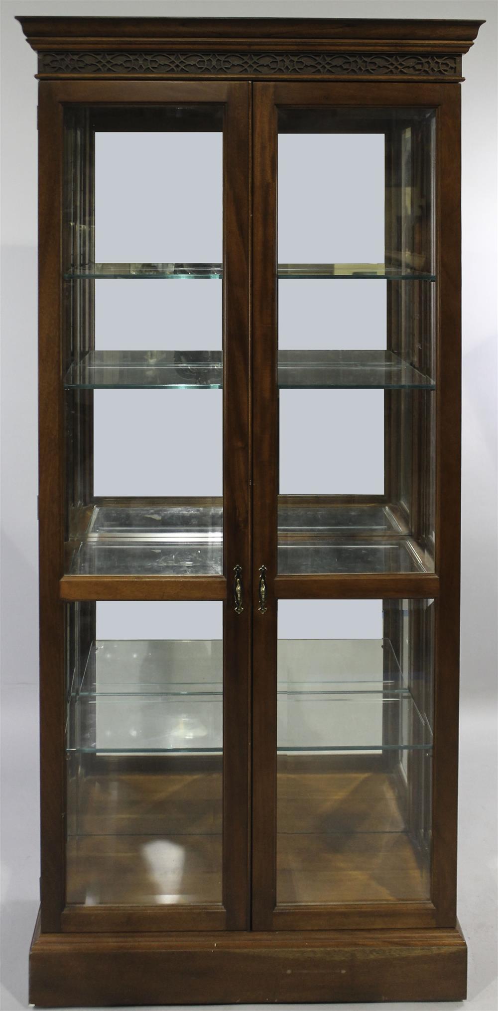 Appraisal: CHIPPENDALE STYLE MAHOGANY AND GLASS CABINET having a molded pediment