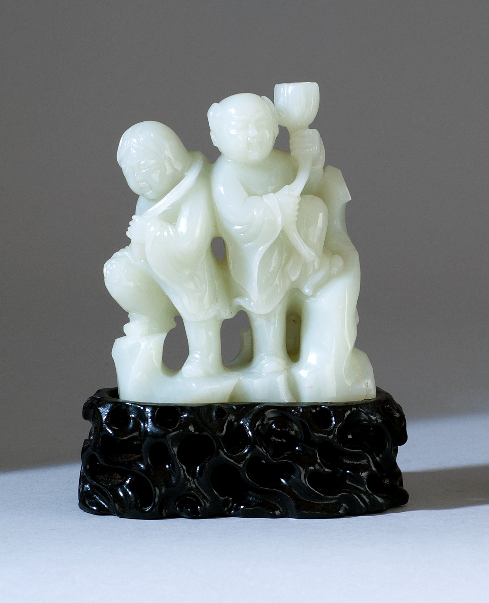 Appraisal: WHITE JADE CARVING Depicting two Immortals with lotus and lotus