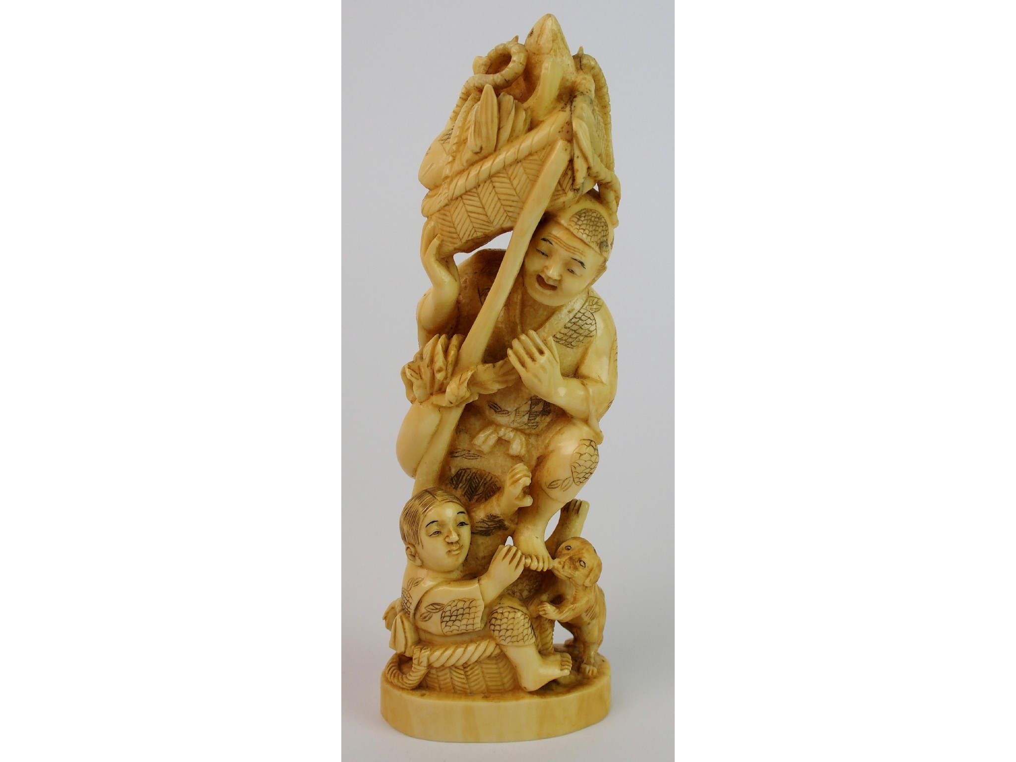 Appraisal: A Japanese ivory okimono of a fishermanwith basket of fish