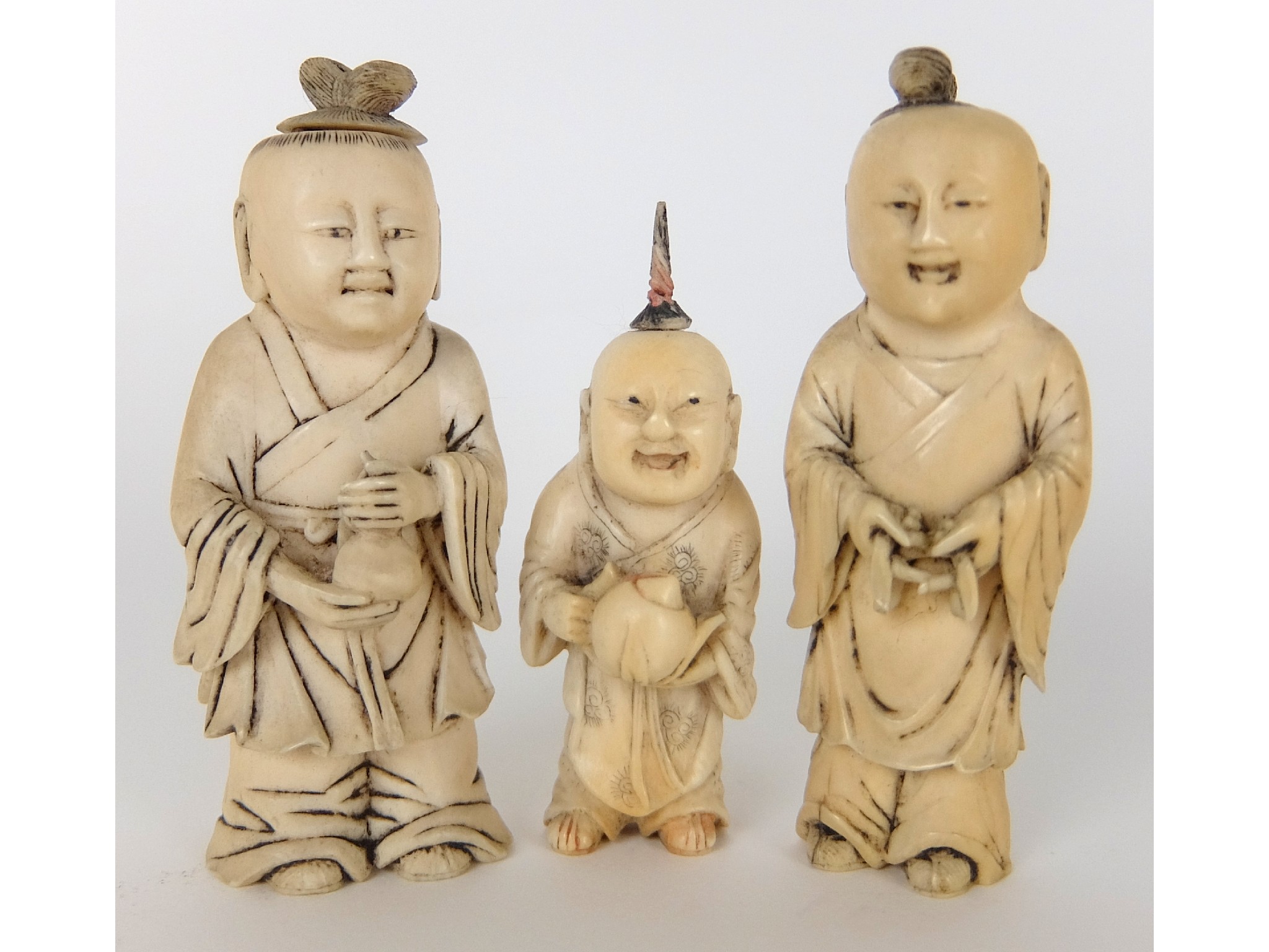 Appraisal: Three Chinese ivory snuff bottlesmodelled as three figures one holding