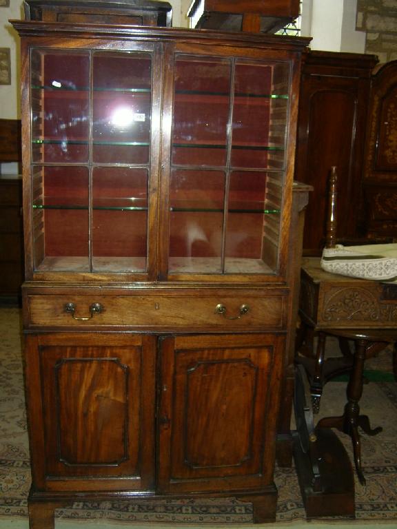 Appraisal: A Georgian mahogany side cabinet the lower section fitted with