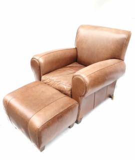 Appraisal: Leather Club chair and Ottoman Leather upholstered club chair with