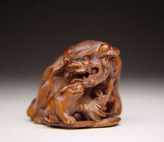 Appraisal: ANTIQUE WOOD NETSUKE Finely carved antique wood netsuke of a