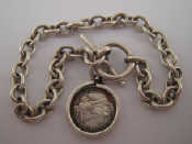 Appraisal: A white metal tests silver bracelet with a silver coin