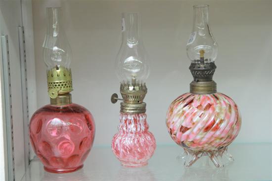 Appraisal: GROUP OF THREE MINIATURE RUBY GLASS LAMPS One ruby glass