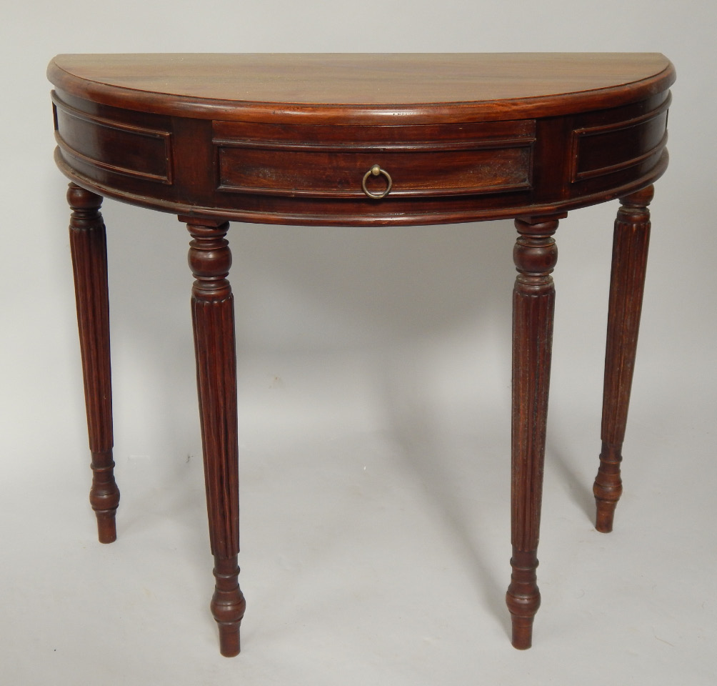 Appraisal: A Regency style demi lune side table fitted with a