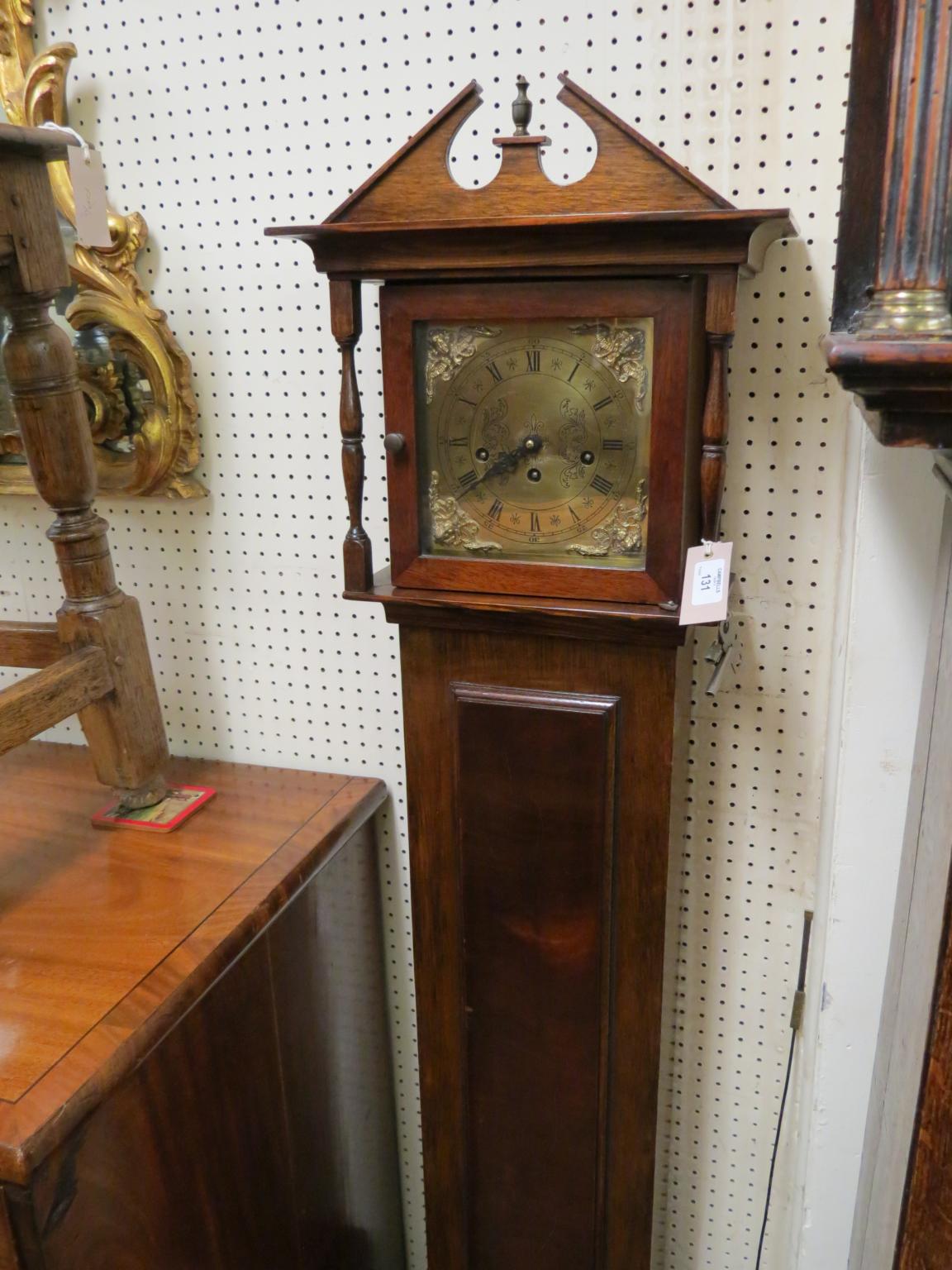 Appraisal: A walnut grandmother clock traditional style with square brass dial