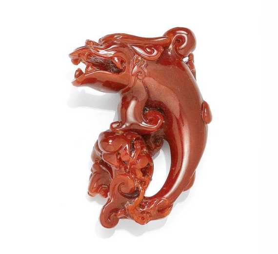 Appraisal: CARVED CORAL Decorative plastically carved coral in the shape of