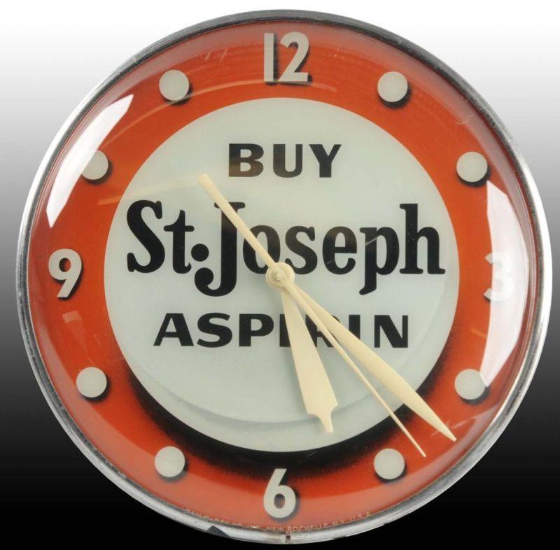 Appraisal: St Joseph Aspirin Electric Light-Up Clock by Pam Description Circa