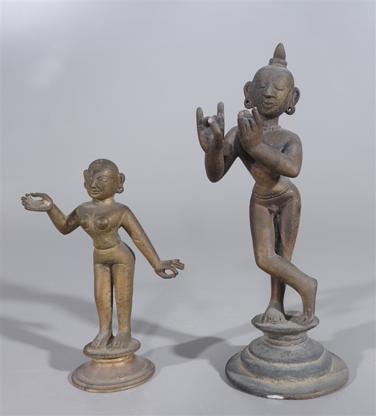 Appraisal: Pair of Indian bronze statues featuring Krishna playing the flute