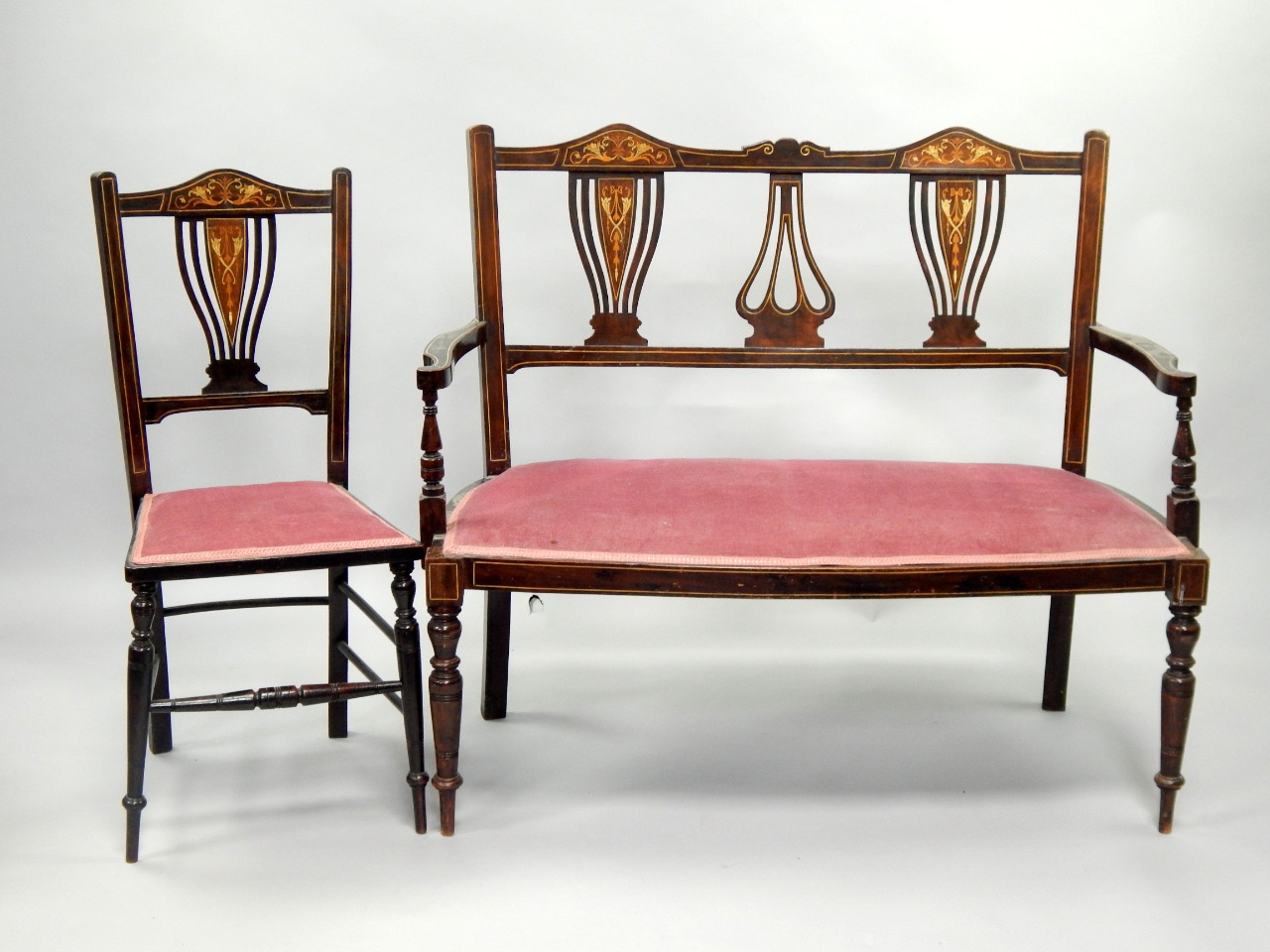 Appraisal: An inlaid mahogany two seater settee with open arms and