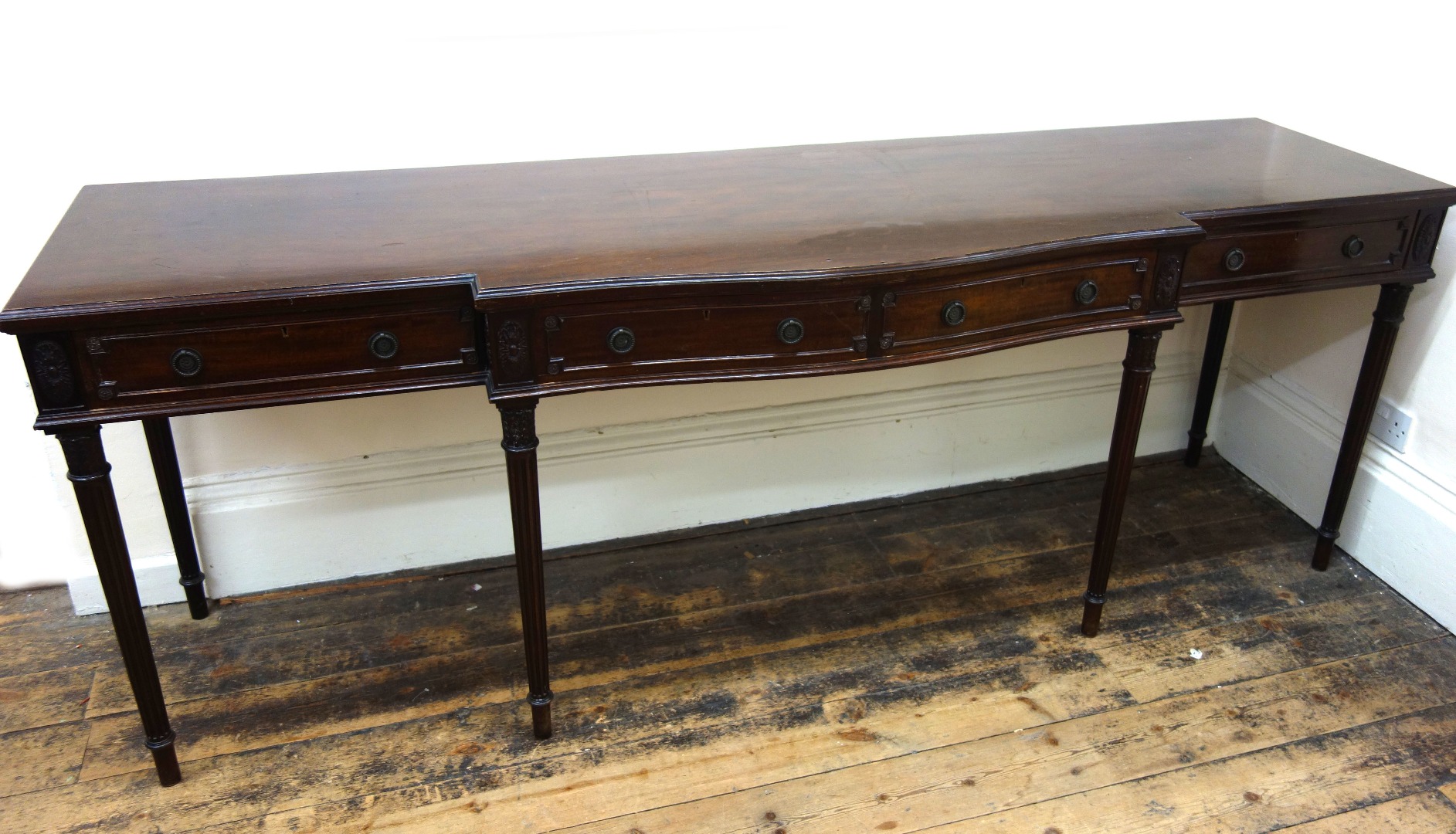 Appraisal: A reproduction Adam style mahogany serpentine breakfront serving table with