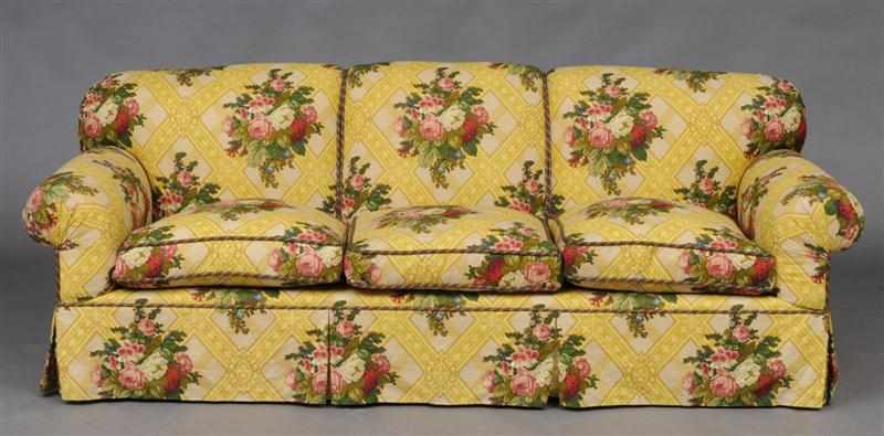 Appraisal: YELLOW-GROUND FLORAL AND TRELLIS PATTERN LINEN UPHOLSTERED THREE-SEAT SOFA in