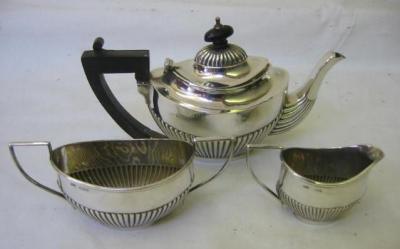 Appraisal: A THREE PIECE BACHELORS TEASET of half fluted oval form