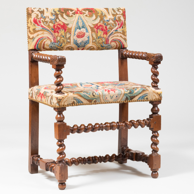 Appraisal: HENRI IV CARVED WALNUT ARMCHAIR With needlework backrest and seat