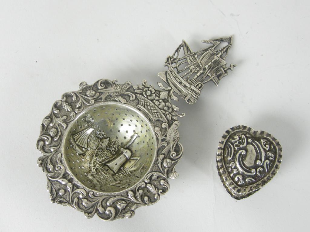 Appraisal: A Dutch silver Tea Strainer with bird and floral surround