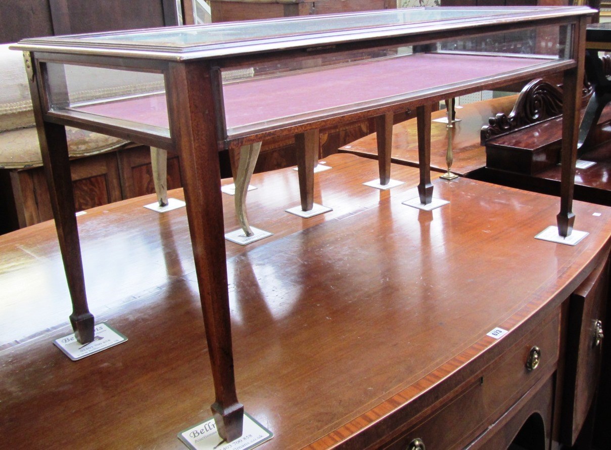 Appraisal: An Edwardian mahogany vertu table on tapering square supports cm