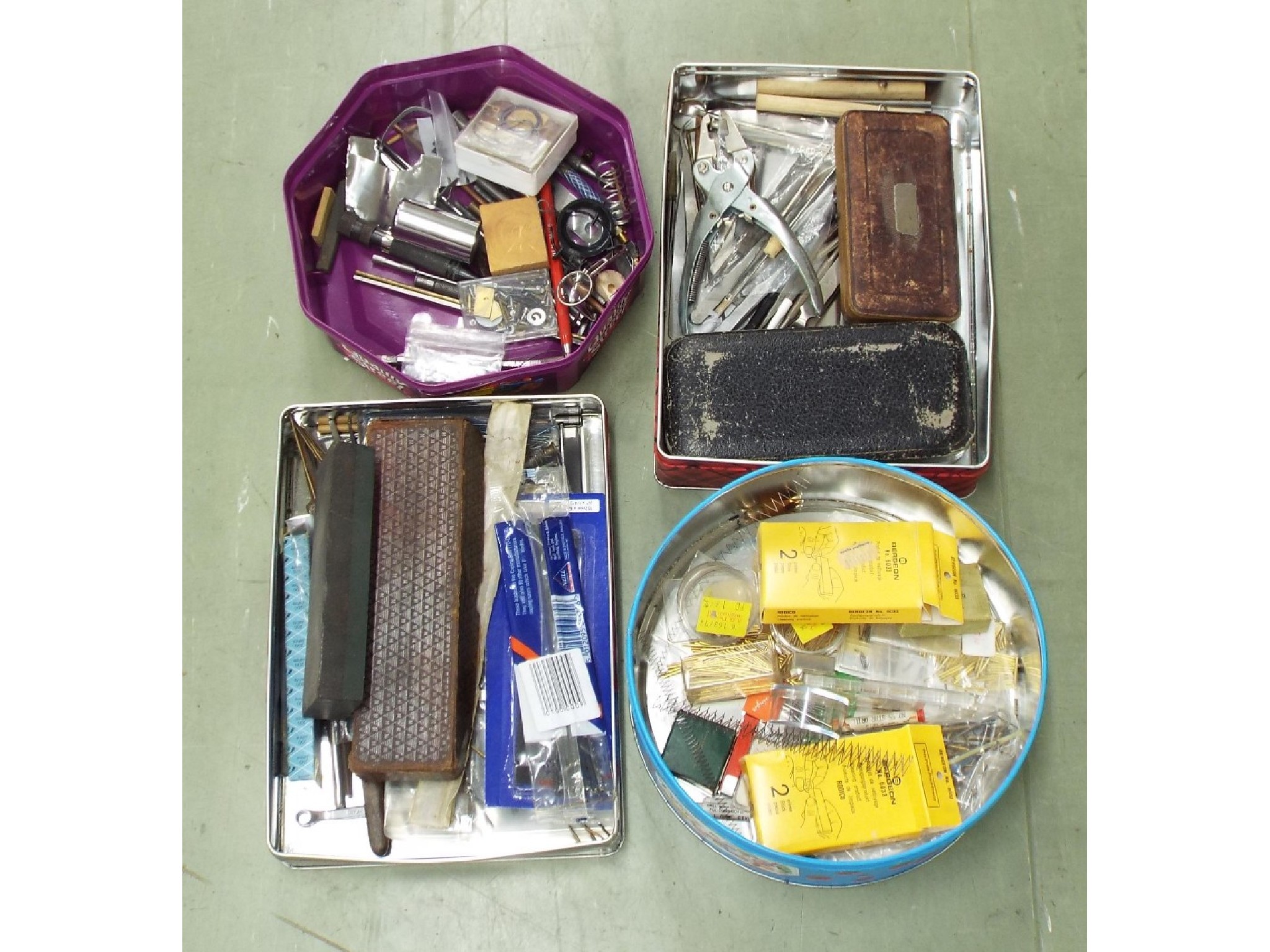 Appraisal: Four tins of assorted watchmakers accessories including various tools drills