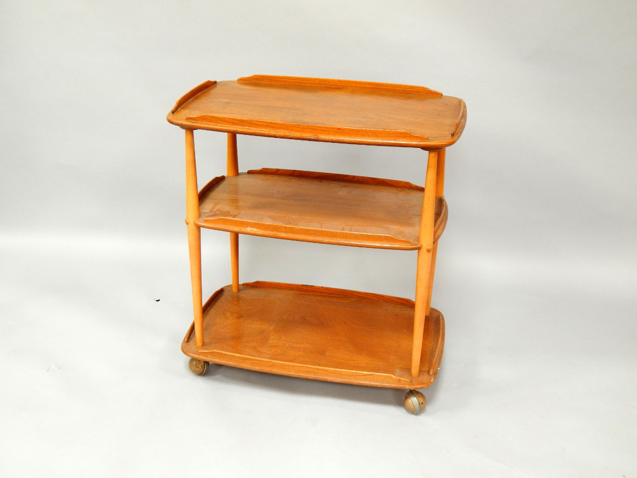 Appraisal: An oak three tier trolley possibly Ercol circa s raised