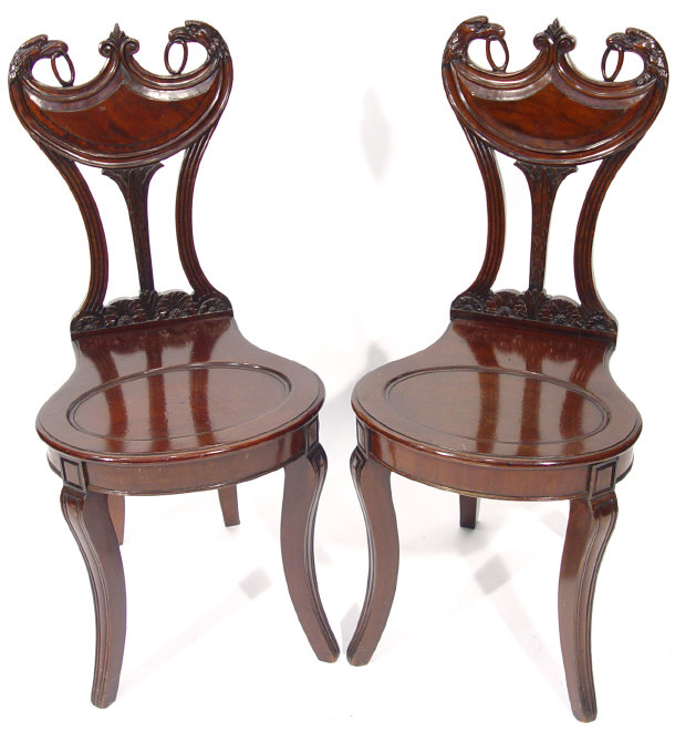 Appraisal: Pair of Regency mahogany hall chairs with eagle and floral