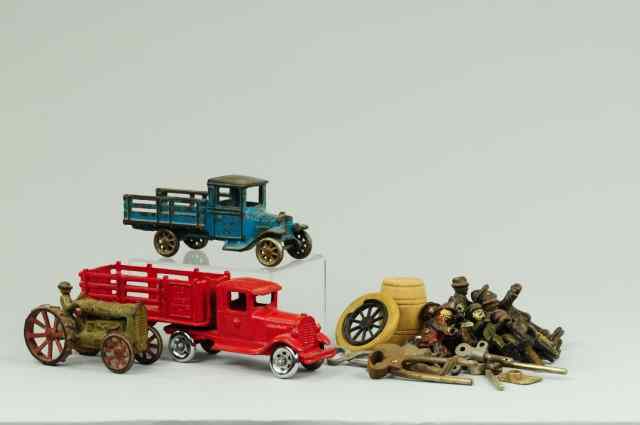 Appraisal: TRUCKS AND PARTS LOT Cast iron grouping includes several figures