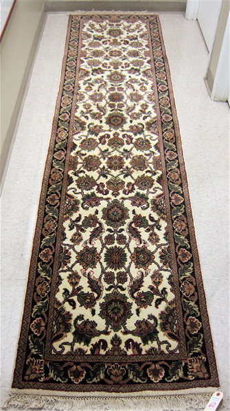 Appraisal: HAND KNOTTED ORIENTAL HALL RUG Indo-Persian overall floral design on