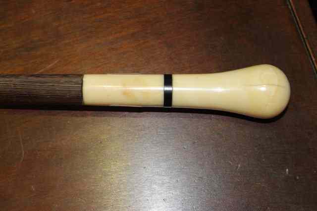 Appraisal: A PITCH PINE WALKING CANE with shaped ivory handle