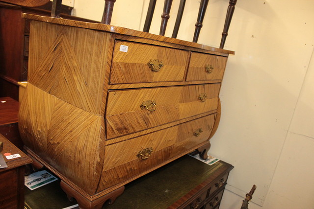 Appraisal: A CONTINENTAL BIRCH VENEERED SERPENTINE TOP COMMODE with two short