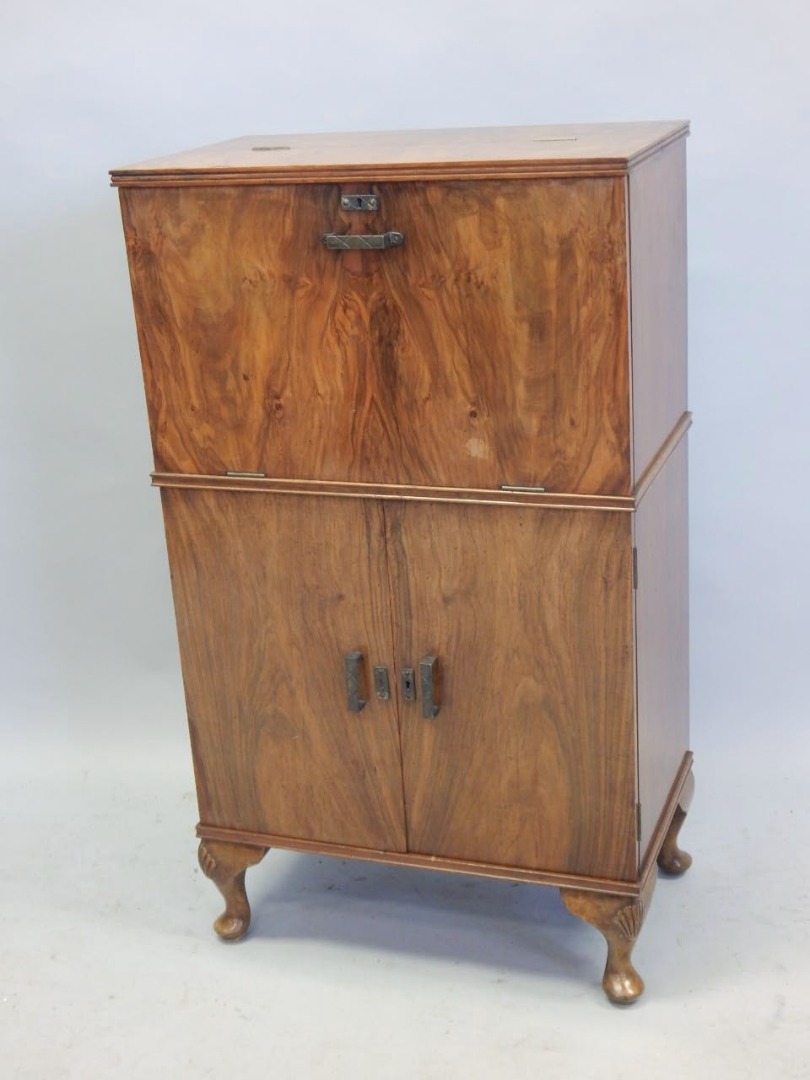 Appraisal: A walnut Art Deco style cocktail cabinet with a fall