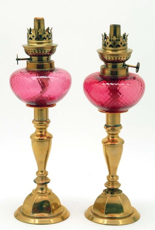 Appraisal: A pair of brass baluster form candlesticks fitted with swirled