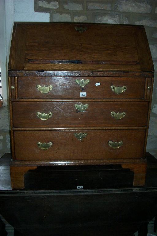 Appraisal: A small th century oak bureau fitted with long graduated