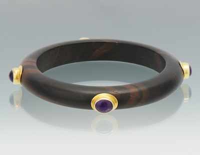 Appraisal: A Carved Mahogany Bangle Bracelet with Amethyst Cabochons Carved wood