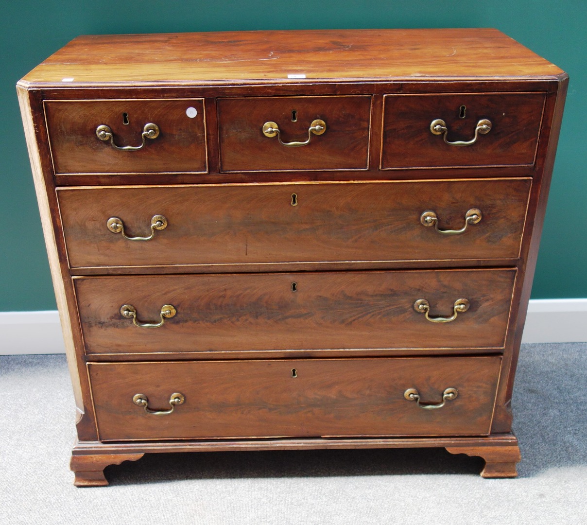 Appraisal: A George III mahogany chest of three short over three