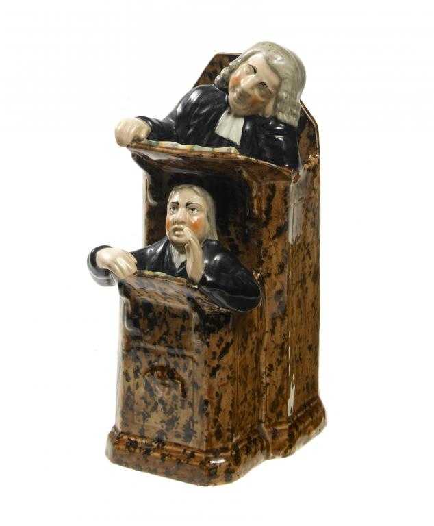 Appraisal: A STAFFORDSHIRE EARTHENWARE VICAR AND MOSES PREACHING GROUP the vicar